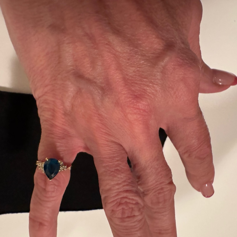 18 karat Gold Pear cut London blue topaz. 6 diamonds Size 6 markings attached